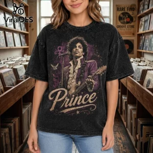 Prince Minneapolis Legacy Vintage Acid Wash T-Shirt featuring Prince holding a guitar with purple accents on dark gray fabric.