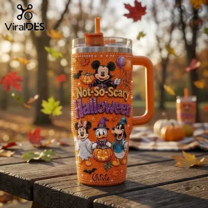 Disney Mickey Mouse Not-So-Scary Halloween 40oz tumbler with orange rhinestones, character graphics, and straw on table.