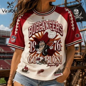 Tampa Bay Buccaneers 1976 Embossed Shirt featuring vintage pirate graphic, red sleeves, and NFL logo on cream fabric.