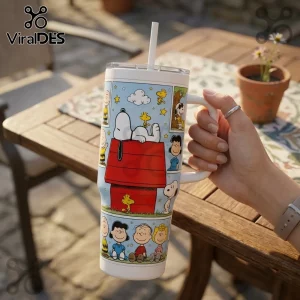 Peanuts Snoopy and Friends 40oz Stanley Tumbler featuring Snoopy on his red doghouse with Woodstock and comic strip panels.
