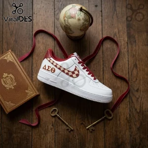 Delta Sigma Theta Nike Air Force 1 Sneakers in white leather featuring crimson Greek letters, a checkered swoosh, and laces.
