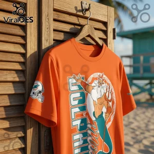 Disney King Triton x Miami Dolphins orange shirt featuring the character with a trident and team helmet graphic print.
