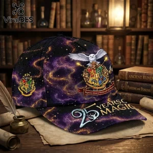 Harry Potter 25th Anniversary Purple Galaxy Cap with Hogwarts crest, white owl, and 25 Years of Magic text on a library desk.