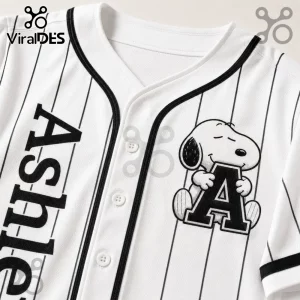 Personalized Snoopy Comic Strip Baseball Jersey featuring white fabric, black pinstripes, and a custom letter patch.