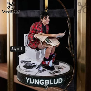 Yungblud Limited Edition 2026 Christmas Ornament featuring the artist sitting on a toilet reading a newspaper on a circular base.