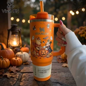 Disney Winnie the Pooh Mickey Mouse Halloween 40oz Tumbler in orange with ghost and pumpkin graphics held by a person.