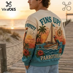 Jimmy Buffett Margaritaville embroidered sweater featuring a sailboat, parrot, sunset, and text on a beige background.