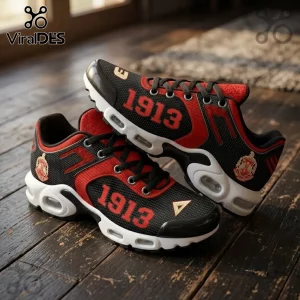 Delta Sigma Theta Sorority Air Max Plus Sneakers in red and black with white soles and 1913 branding on wooden floor.