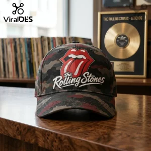 The Rolling Stones Premium Camo Baseball Cap featuring the iconic red tongue logo and white text on a woodland camo pattern.