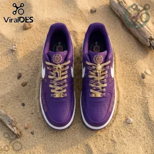 Omega Psi Phi Fraternity Purple Air Force 1 Sneaker with metallic gold laces and custom branding on a sandy beach background.