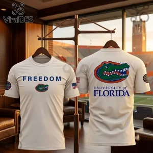 University of Florida Freedom White T-Shirt featuring front and back logos of the Gator mascot and text on a wood rack.