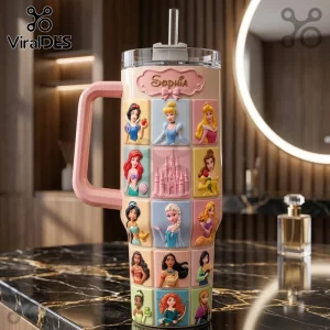 Sophia Magic Princess 40oz Tumbler in cream with embossed colorful grid panels of fairy tale characters and a pink handle.