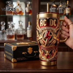 AC/DC Rock Royalty Gold Embossed Stanley Tumbler with ruby red accents, lightning bolt emblem, and matching storage box.