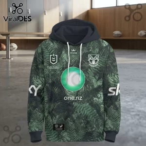 New Zealand Warriors 2026 Junior Te Taiao hoodie featuring a green fern print, black hood, and team sponsor logos.