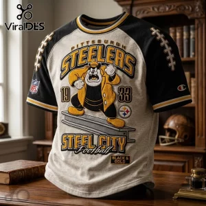 Pittsburgh Steelers NFL mascot shirt featuring a cartoon character on a heather grey body with black raglan sleeves.