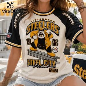 Pittsburgh Steelers NFL Mascot Shirt in cream and black with Pete mascot, 1933 graphics, and team logo on jersey sleeves.