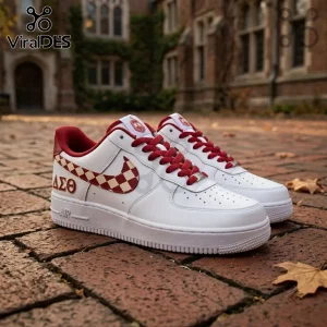 Delta Sigma Theta Nike Air Force 1 Sneakers in white leather with red checkered swoosh and Greek letters on a brick path.
