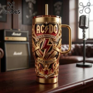 AC/DC Rock Royalty Gold Embossed Stanley Tumbler with red accents, metallic lightning bolt, and ruby-like jewel embellishments.