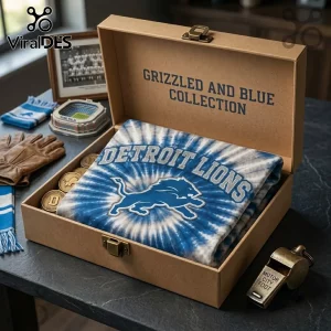 Detroit Lions NFL Mascot Blue Tie Dye Shirt folded in a branded kraft box with team-themed memorabilia and a metal whistle.