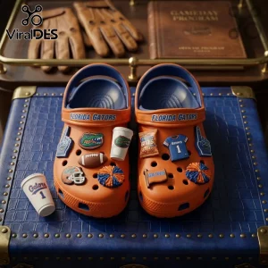 Florida Gators Orange Rubber Crocs With Charms featuring a football, jersey, and mascot icons on a blue textured surface.