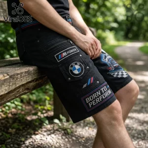 BMW M Performance black cargo shorts featuring M Power patches, a BMW logo, and Born to Perform text in a park setting.