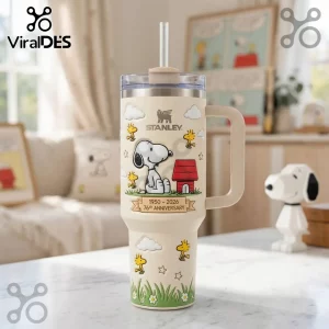 Snoopy x Stanley 76th Anniversary Cream 40oz Tumbler featuring Snoopy, Woodstock, and a red doghouse on a cream body.