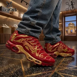 Spain National Team World Cup Air Max Plus Shoes in red and gold with crown motifs on a person wearing blue jeans.