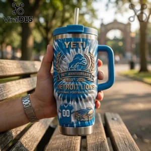 Detroit Lions 96th Anniversary Tie Dye YETI Tumbler with team logo, stadium graphic, and blue jersey print held in hand.