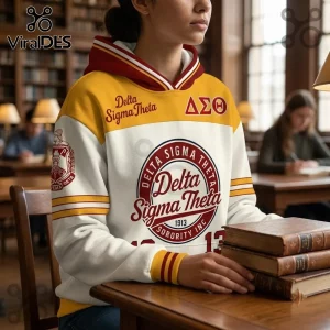 Delta Sigma Theta Crimson and Gold Hoodie featuring Greek letters and sorority branding, worn by a student in a library.