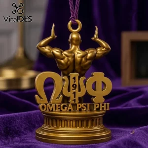 Omega Psi Phi Gold Christmas Ornament 2026 featuring a muscular figure standing behind Greek letters on a purple background.
