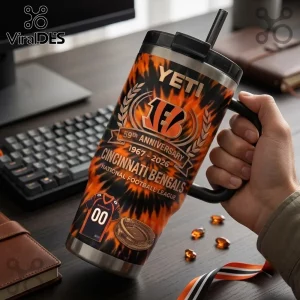 Cincinnati Bengals 59th Anniversary Stanley Tumbler with orange black flame design, team logo, and jersey graphic on desk.