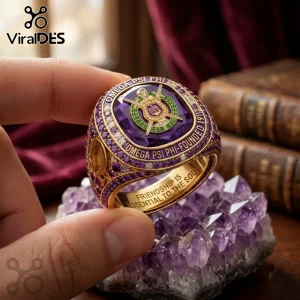 Omega Psi Phi Fraternity Premium Gold Ring featuring a large purple stone, Greek symbols, and gold lettering on a band.