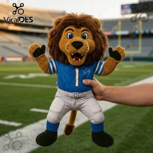 NFL Detroit Lions Mascot Plush Toy wearing a blue number 1 jersey and grey football pants on a stadium field background.