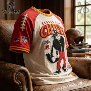 Kansas City Chiefs NFL mascot embroidered shirt with red sleeves, cream body, and wolf character graphic on leather chair.