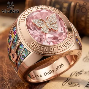 Dolly Parton Queen of Country Butterfly Ring in rose gold with a pink stone, butterfly accent, and guitar side motifs.