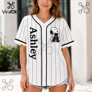 Personalized Snoopy Comic Strip Baseball Jersey featuring a white pinstripe design, black trim, and custom name Ashley.