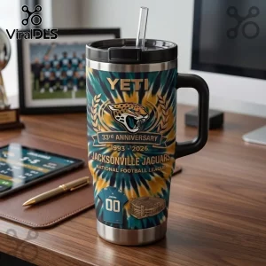 Jacksonville Jaguars 33rd Anniversary YETI 40oz Tumbler with team logo, tie-dye pattern, and stadium graphic on a desk.