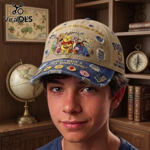 Winnie the Pooh Woodland Friends distressed baseball cap in tan and blue with character graphics and anniversary text.