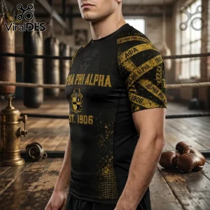 Alpha Phi Alpha 1906 compression turtleneck shirt in black with gold graphics and fraternity crest in a boxing gym setting.