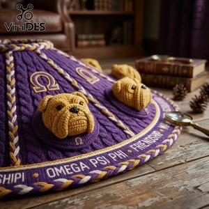 Omega Psi Phi Purple Bulldog Christmas Tree Skirt with raised knit faces and gold Greek lettering on a wooden floor.