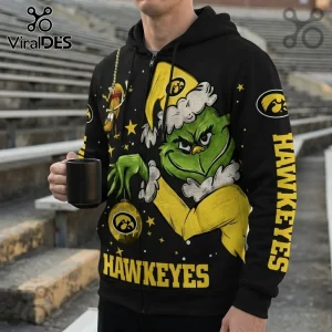 Iowa Hawkeyes Grinch Christmas holiday hoodie featuring a green character, yellow Hawkeyes branding, and black background.