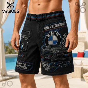 BMW M Performance black cargo shorts featuring embroidered car graphics, logos, and checkerboard racing patterns.
