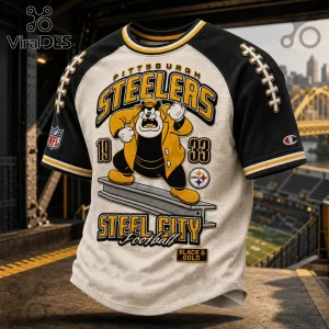 Pittsburgh Steelers NFL Mascot Shirt featuring a cartoon character on a steel beam with team branding and 1933 text.