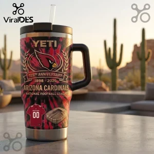 Arizona Cardinals Tie-Dye 40 oz Handle Tumbler with 128th anniversary logo and stadium graphic on a desert patio backdrop.
