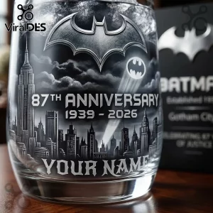 Batman 87th Anniversary Custom Whiskey Glass featuring Gotham City skyline, bat-signal, and 1939-2026 text etched in glass.