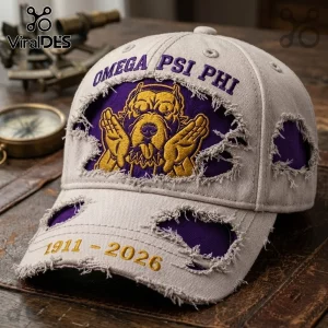 Omega Psi Phi 1911-2026 Distressed Mascot Baseball Cap with purple embroidery and a gold bulldog mascot on a beige base.