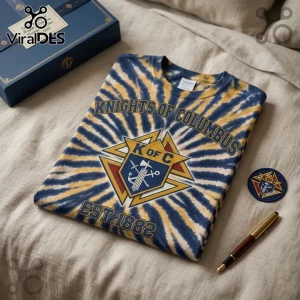 Knights of Columbus EST1882 Tie Dye T-Shirt with blue and yellow spiral patterns, K of C emblem, and text on a fabric bed.