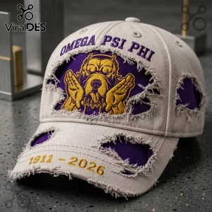 Omega Psi Phi 1911-2026 Distressed Mascot Baseball Cap featuring a beige fabric base, purple embroidery, and bulldog graphic.