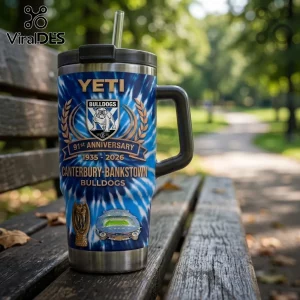 Canterbury-Bankstown Bulldogs 91st Anniversary Stanley Tumbler with blue tie-dye pattern on a wooden park bench.