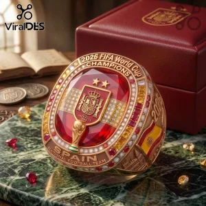 Spain 2026 World Cup Gold Championship Ring featuring a red stone, the Spanish crest, and encrusted diamonds on a surface.